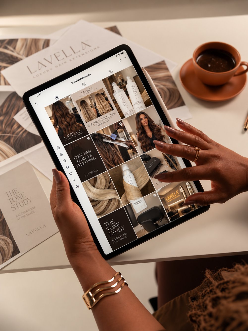 Mayra Bennett reviewing a client’s social media grid on a tablet